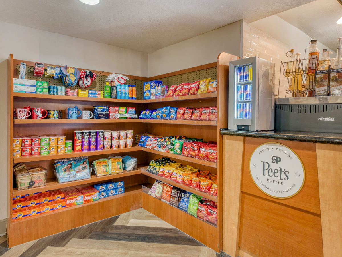 The image shows a small snack shop with shelves of chips, snacks, and a Peet's Coffee station with a beverage machine.